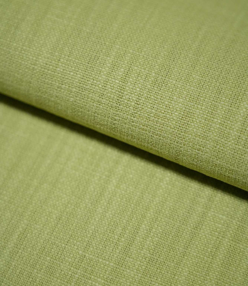 Close-up of Waverley Celery fabric gently folded, revealing its fine basket-like weave, textured surface and muted green colour.