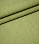 Waverley Celery green upholstery-style fabric arranged in overlapping folds, highlighting its woven texture and subtle tonal variations.