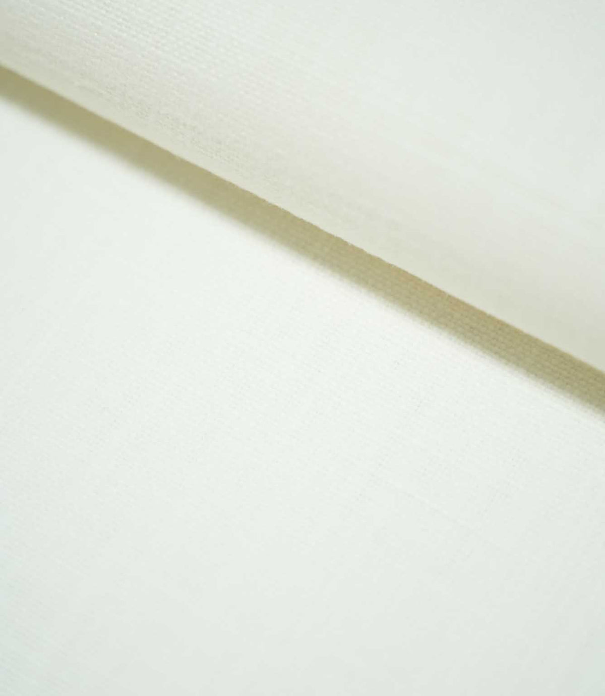 Close-up of Waverley Chalk fabric folded over itself, revealing its soft off-white colour, subtle weave and gently textured surface.