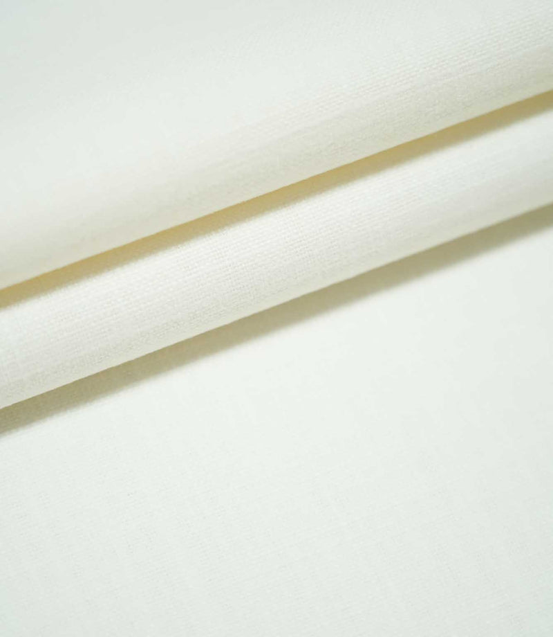 Waverley Chalk plain off-white fabric arranged in overlapping folds, showcasing its fine woven texture and soft, neutral appearance.