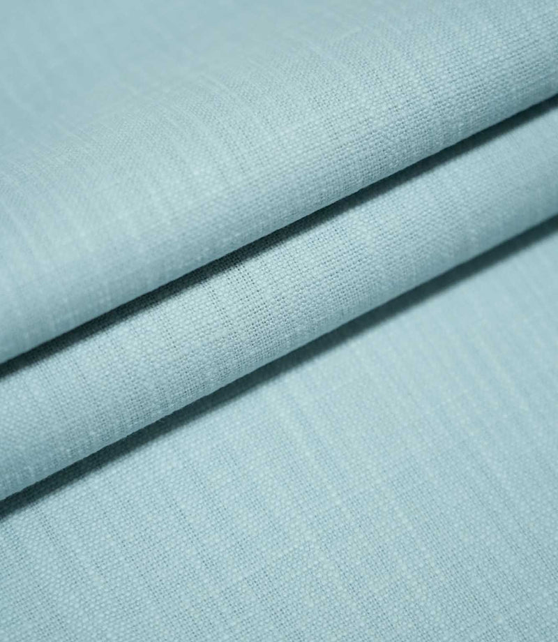 Waverley Duck Egg plain cotton fabric arranged in overlapping folds, showcasing its soft brushed finish, fine woven structure and delicate duck egg blue colouring.