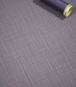 Waverley Heather brushed cotton fabric laid flat with a coordinating deep purple thread spool, highlighting its woven texture and muted lavender-grey colouring.