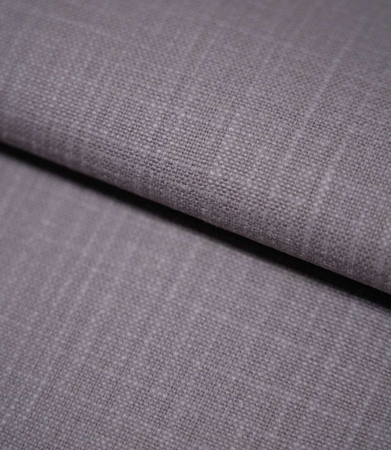 Waverley Heather 100% cotton curtain and upholstery fabric arranged in a soft fold, showing its fine woven structure and understated mauve-purple shade.