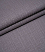 Waverley Heather plain brushed cotton fabric arranged in overlapping folds, showcasing its soft finish, subtle woven texture and dusty purple-grey colouring.