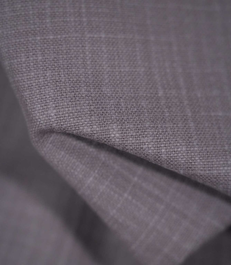 Detailed close-up of Waverley Heather brushed cotton fabric draped into a curved fold, revealing its closely woven texture and muted heather-purple appearance.