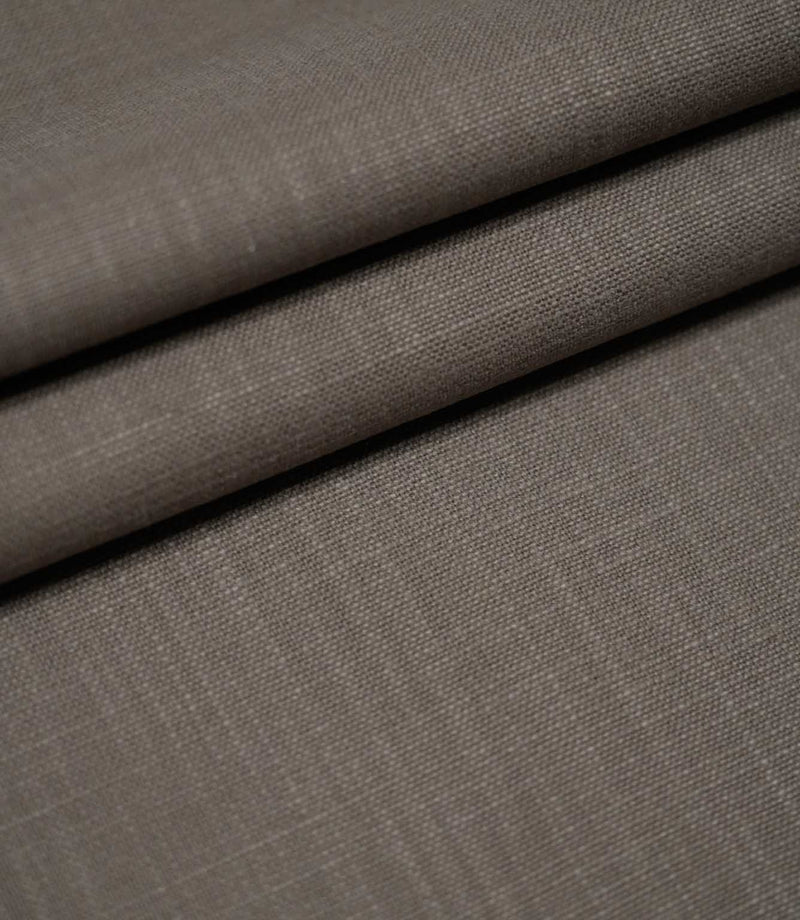 Waverley Mink brushed cotton upholstery and curtain fabric arranged in overlapping folds, showcasing its subtle woven texture, soft finish and muted brown-grey colouring.