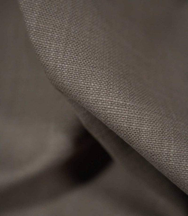 Detailed close-up of Waverley Mink 100% brushed cotton fabric draped over a curved fold, highlighting the tightly woven structure, soft brushed finish and warm taupe-grey shade.