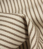 Detailed close-up of Wedmore Wide ivory fabric featuring raised taupe embroidered stripes on a cream woven base.