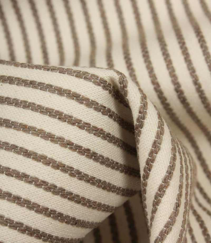 Detailed close-up of Wedmore Wide ivory fabric featuring raised taupe embroidered stripes on a cream woven base.