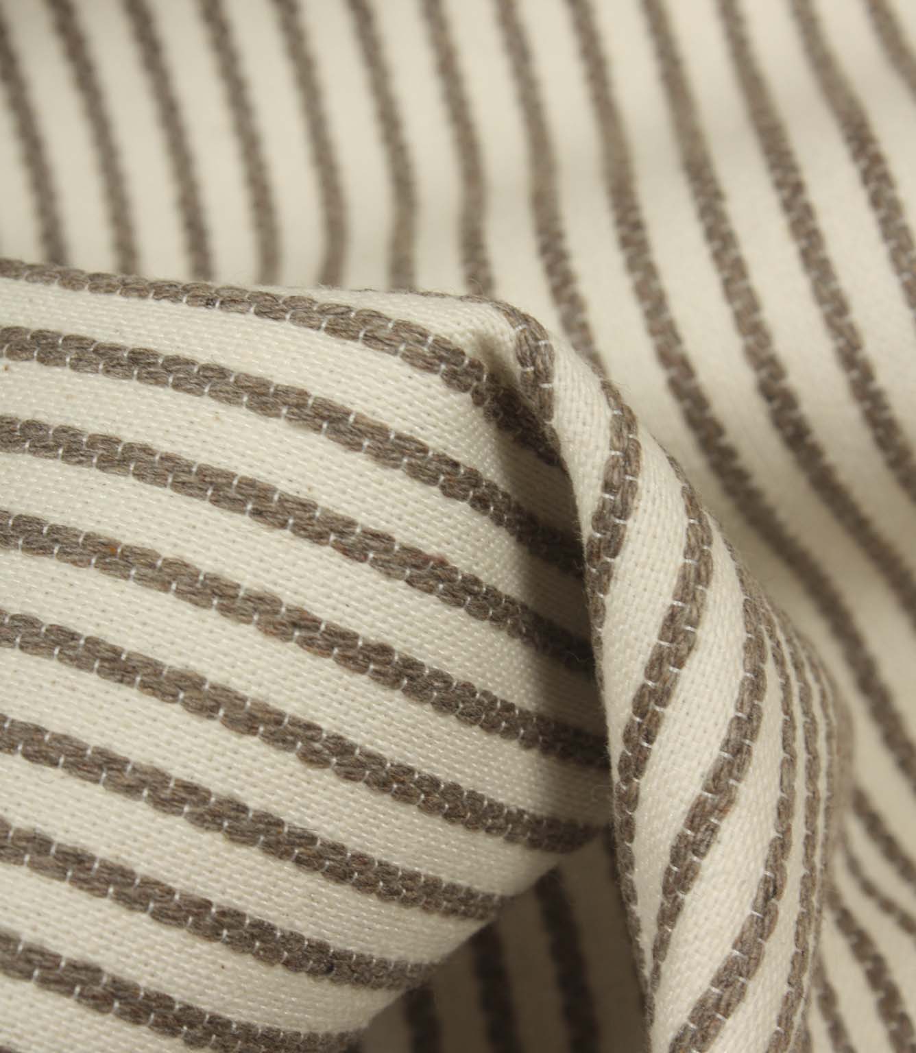 Detailed close-up of Wedmore Wide ivory fabric featuring raised taupe embroidered stripes on a cream woven base.