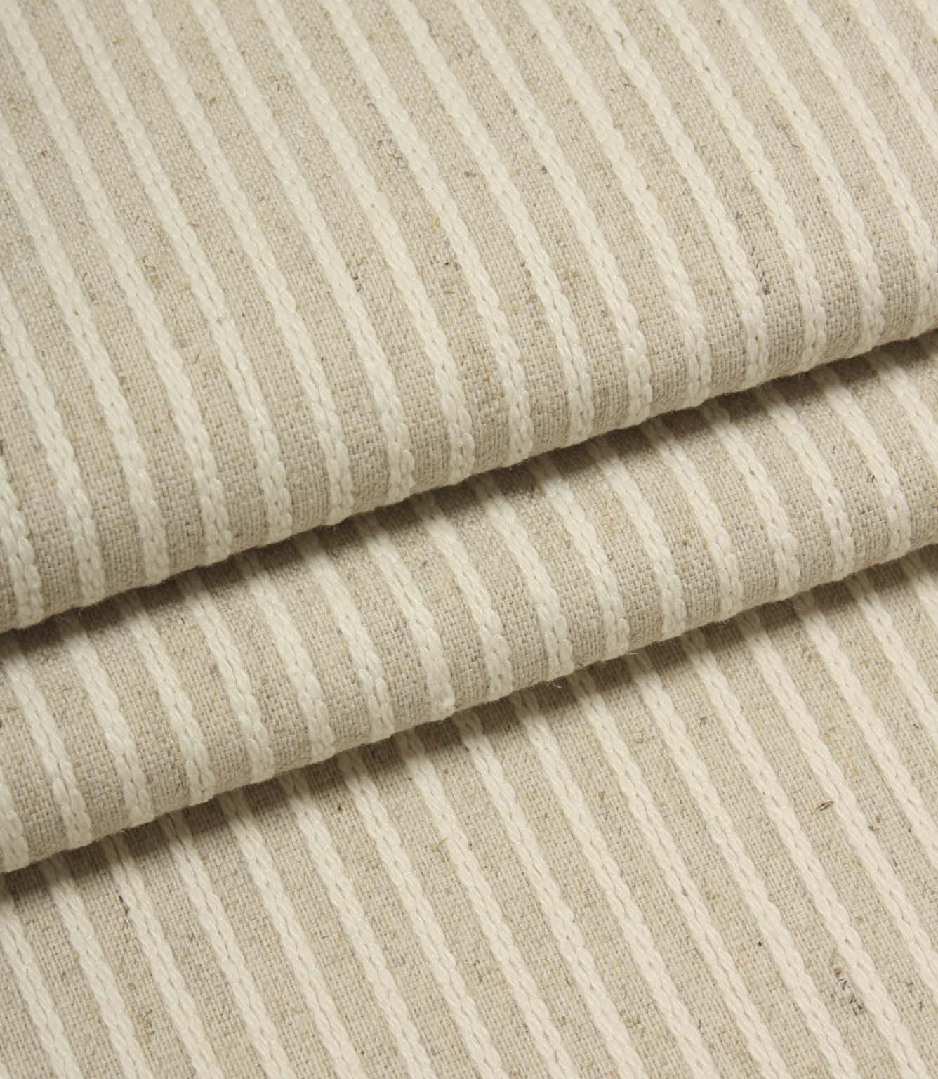 Folded Wedmore Wide woven fabric showcasing fine embroidered stripe detailing and a natural upholstery finish.