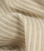 Detailed close-up of Wedmore Wide upholstery fabric featuring raised embroidered stripes on a natural woven background.