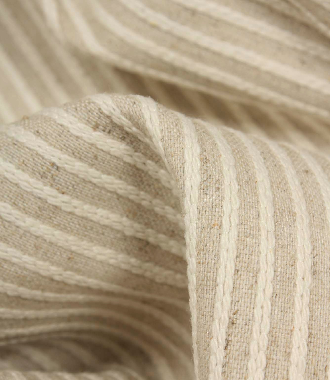 Detailed close-up of Wedmore Wide upholstery fabric featuring raised embroidered stripes on a natural woven background.