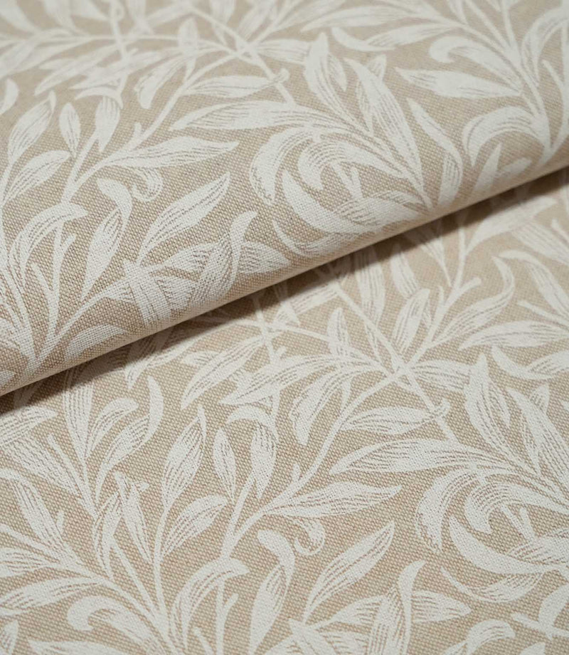 Folded Willow Bough Linen Look fabric in warm beige and cream, highlighting the repeating leafy pattern and textured linen-look weave.