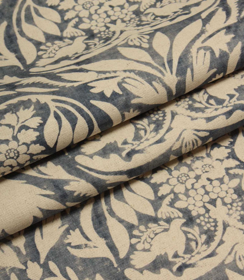 Floral and leaf patterned fabric in blue and beige