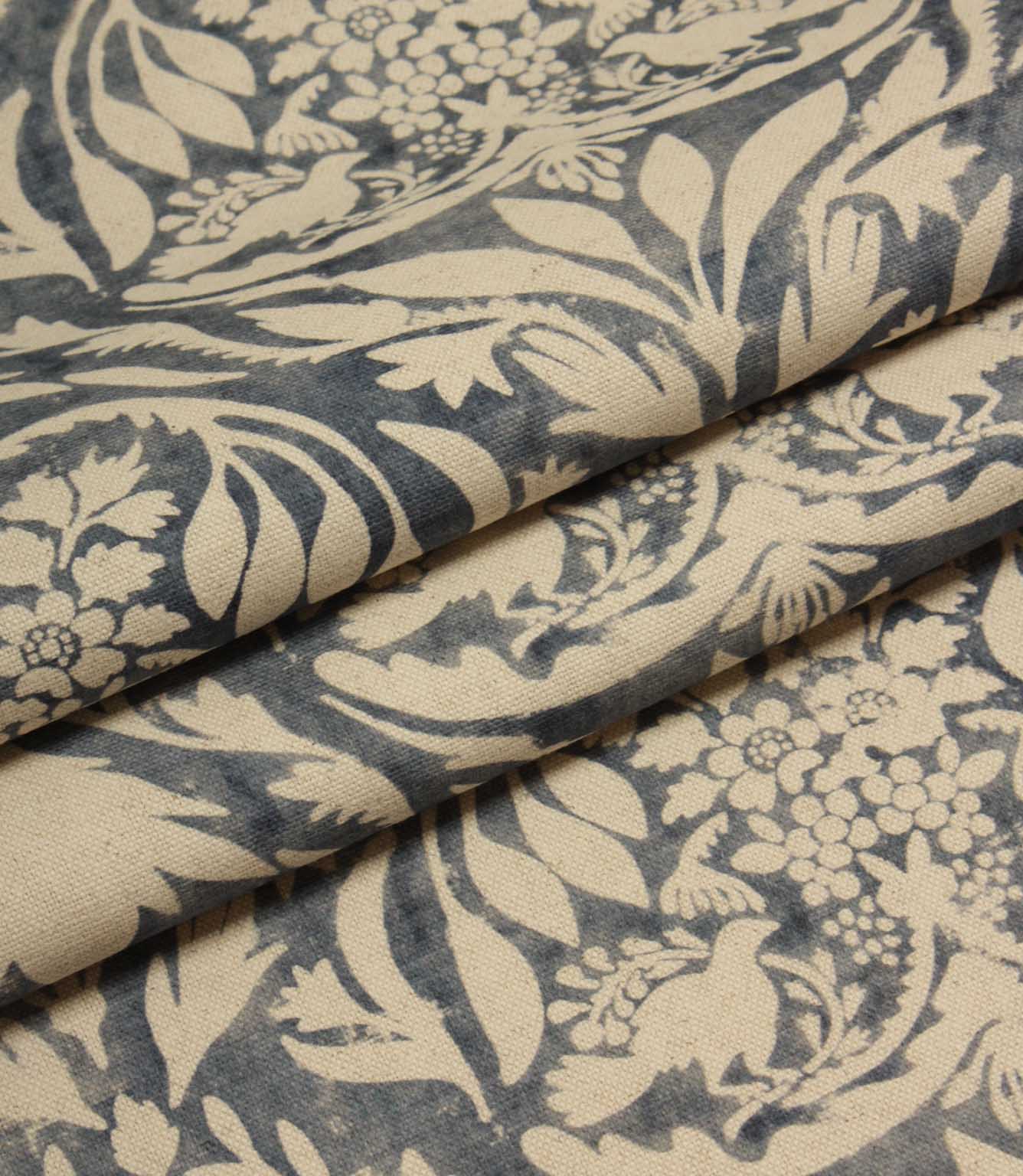 Floral and leaf patterned fabric in blue and beige