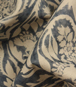 Close-up of fabric with blue floral pattern on beige background