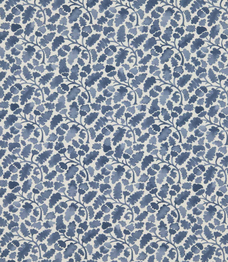 Woodcliff Nautica fabric featuring a small-scale Scandinavian-inspired botanical pattern of stylised oak leaves, acorns and delicate branching stems in varying shades of navy and muted blue against an ivory background.