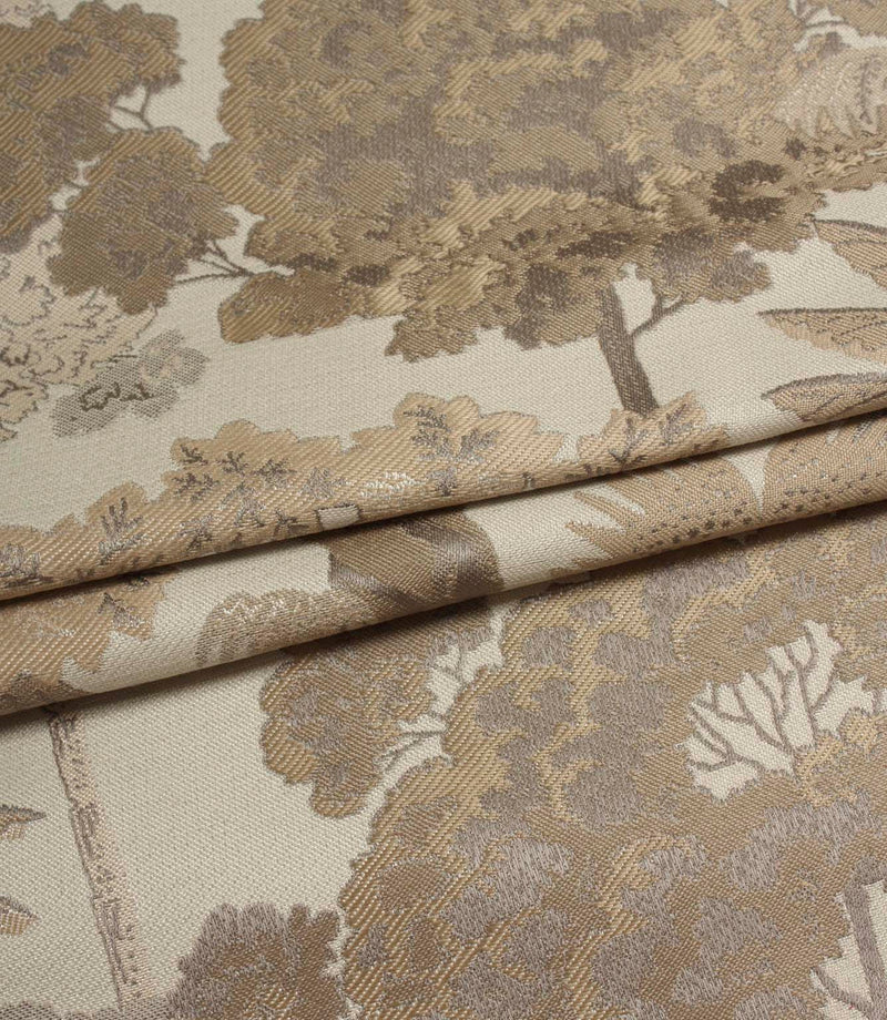 Folded Woodlands Natural fabric displaying the decorative woodland motif, featuring trees, leafy canopies and subtle tonal detailing.