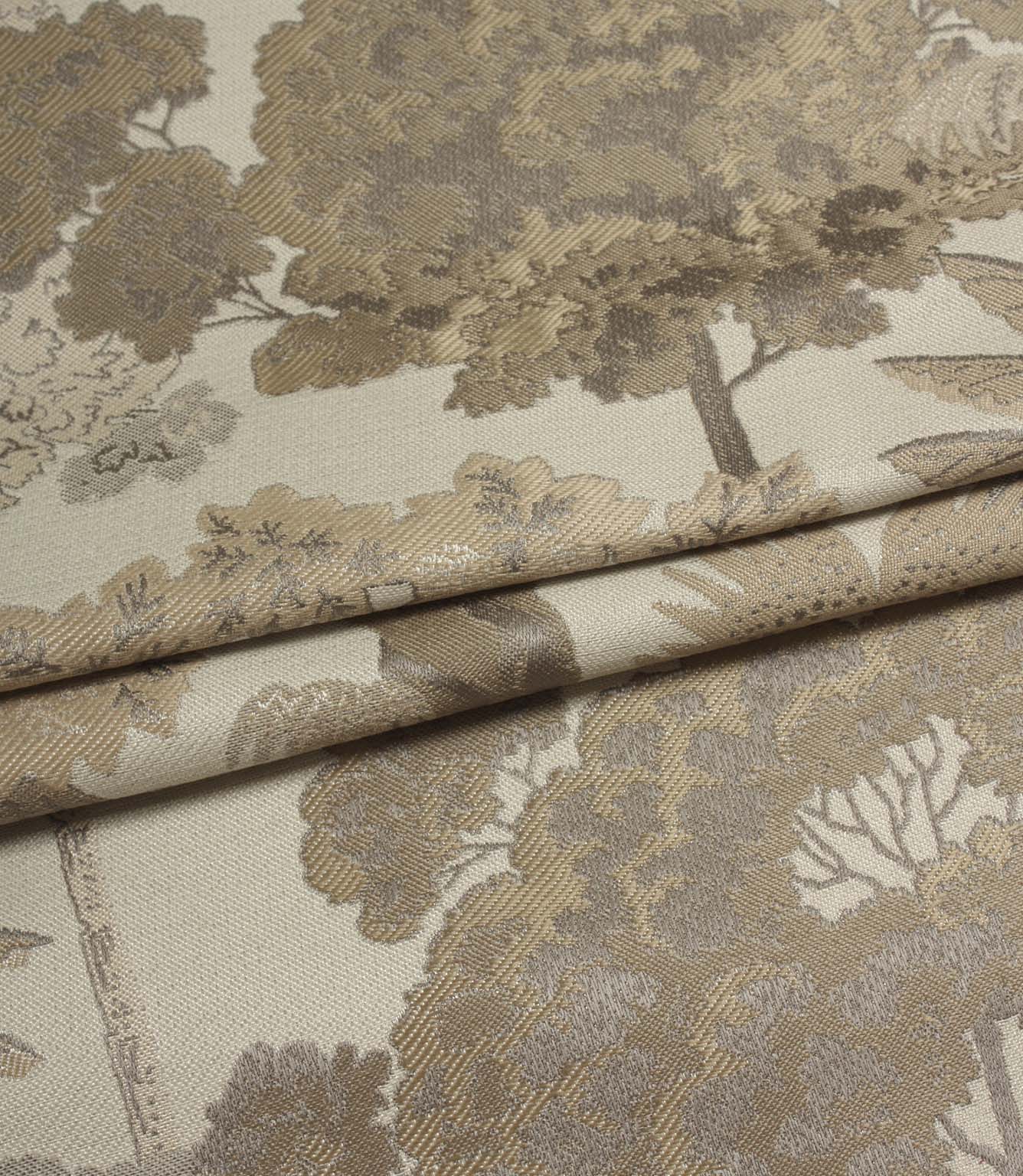 Folded Woodlands Natural fabric displaying the decorative woodland motif, featuring trees, leafy canopies and subtle tonal detailing.