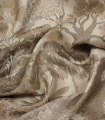 Draped Woodlands Natural fabric emphasising the luxurious handle, soft sheen and intricate woven woodland design in natural shades.