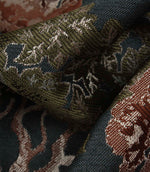 Macro close-up of Woodlands Navy fabric revealing the intricate jacquard construction, textured leaves and contrasting woven yarns.
