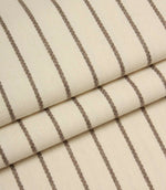 Folded Wooton Wide woven fabric showcasing embroidered stripe detailing and a soft upholstery finish.