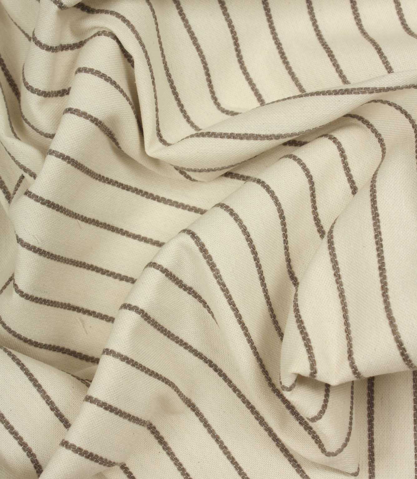 Draped Wooton Wide striped fabric with flowing folds, showing its relaxed woven texture and embroidered stripe pattern.