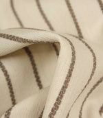Detailed close-up of Wooton Wide upholstery fabric featuring raised embroidered stripes on a soft woven surface.