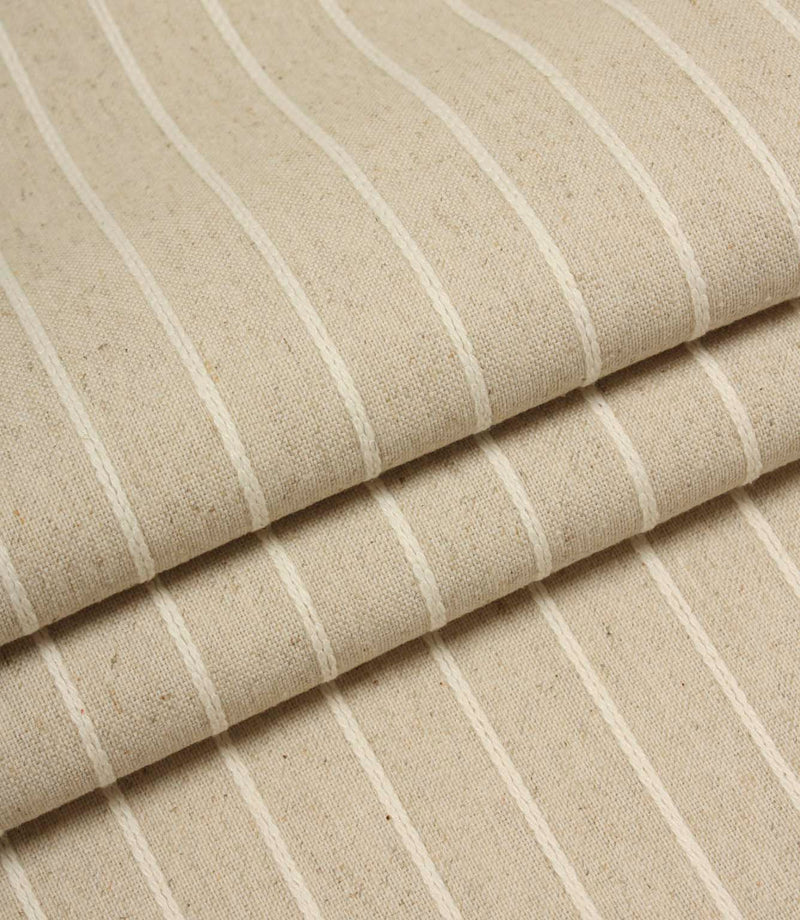 Folded Wooton Wide upholstery fabric featuring embroidered stripe detailing and a relaxed woven finish.