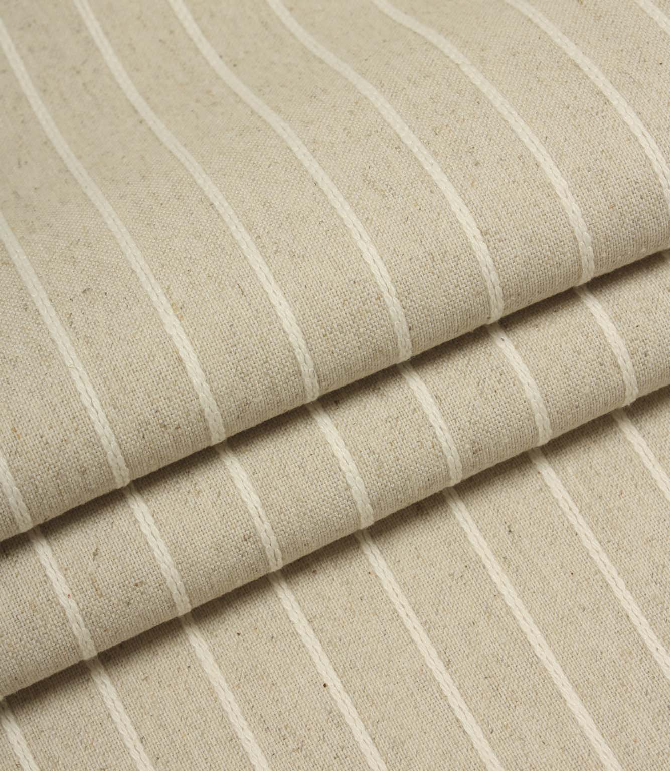 Folded Wooton Wide upholstery fabric featuring embroidered stripe detailing and a relaxed woven finish.