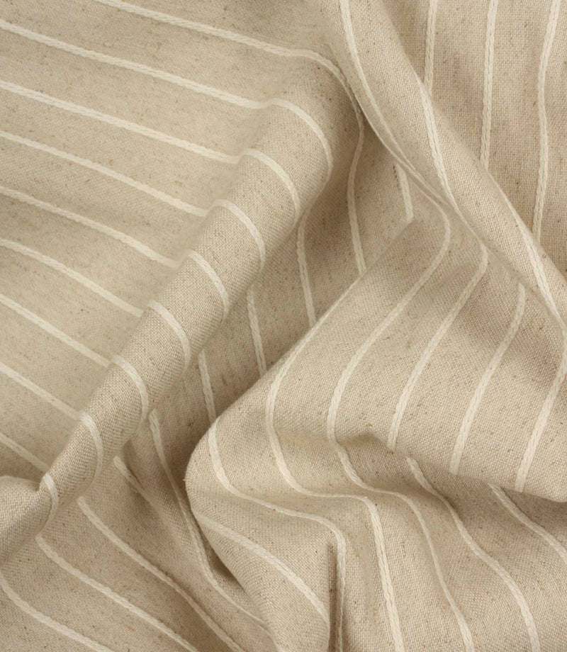 Draped Wooton Wide striped fabric showcasing its soft handle and natural woven texture for curtains and cushions.