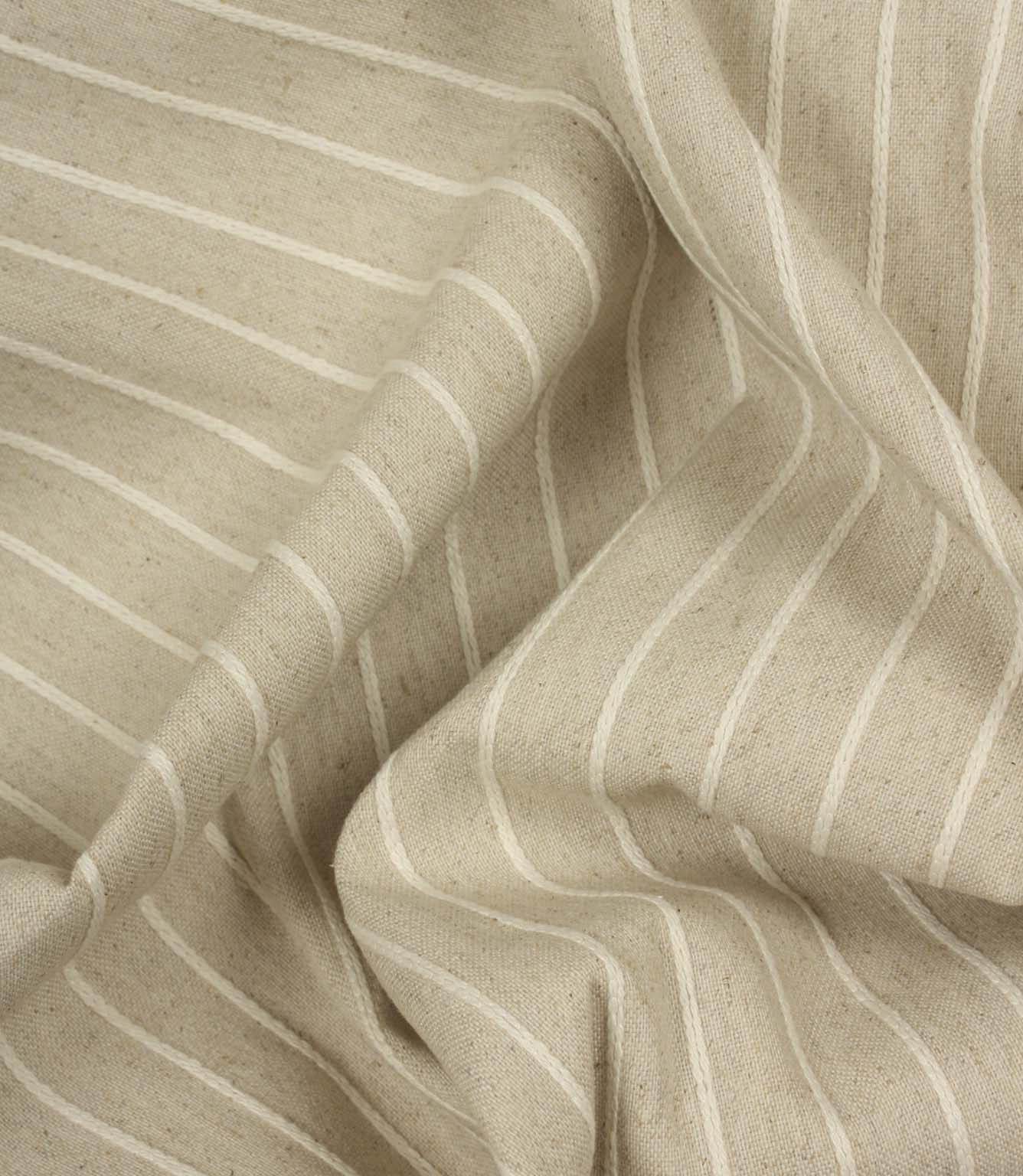 Draped Wooton Wide striped fabric showcasing its soft handle and natural woven texture for curtains and cushions.