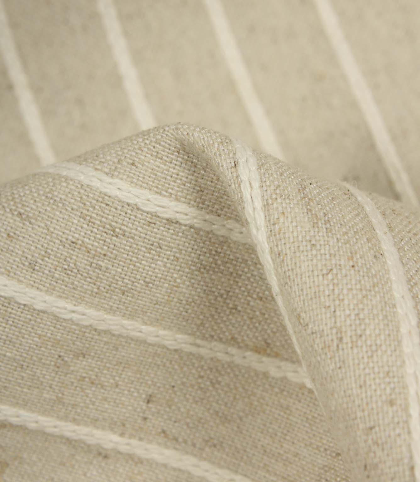Detailed close-up of Wooton Wide embroidered stripe upholstery fabric with textured woven construction.