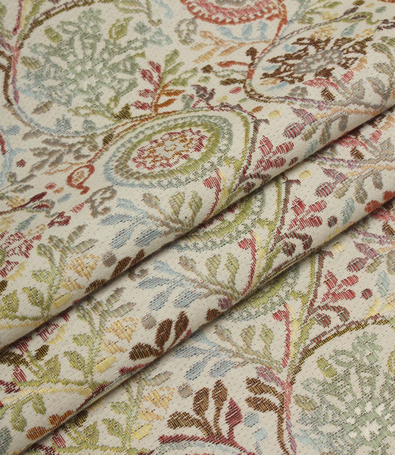 Folded Wychwood Jasmine woven fabric showcasing the detailed floral and foliage pattern in soft blue, green, coral and neutral tones.