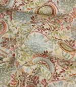 Draped Wychwood Jasmine fabric revealing the texture, movement and multicoloured botanical design on a natural-look background.