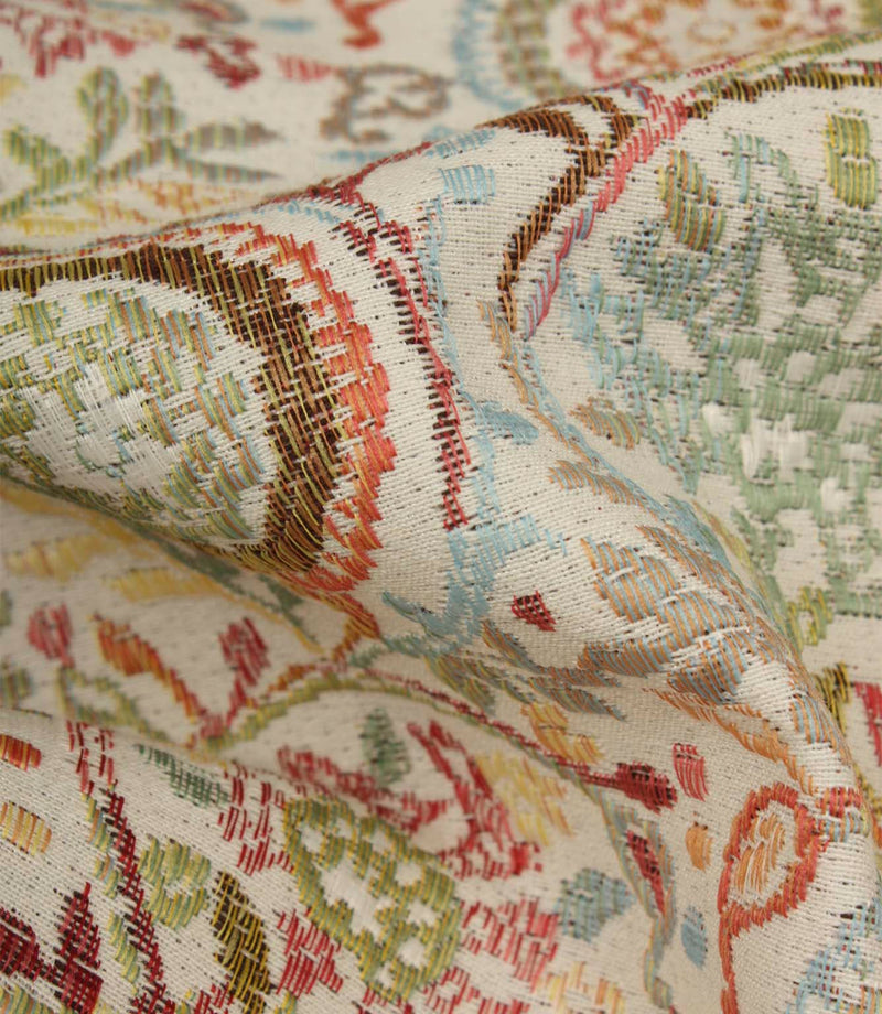 Detailed close-up of Wychwood Jasmine woven upholstery fabric highlighting the intricate floral weave in blue, green, coral, brown and cream tones.